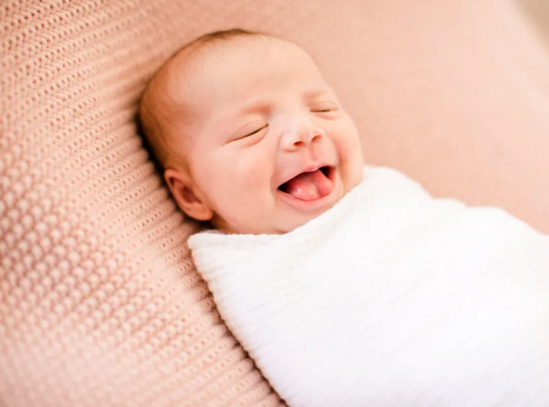 Newborn asleep in a soft blanket
