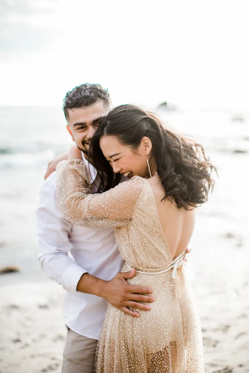 Couple laughing on the beach
