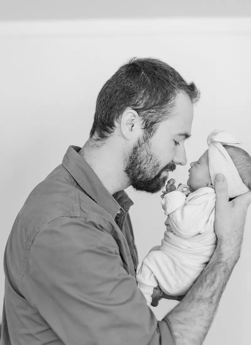 A father holding his newborn close