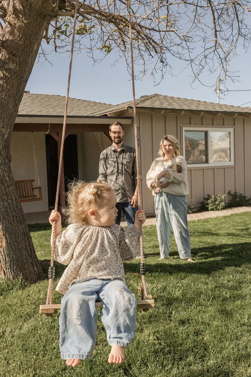 Kids on a swing in the backyard