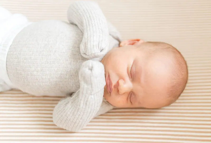Newborn asleep in soft knit
