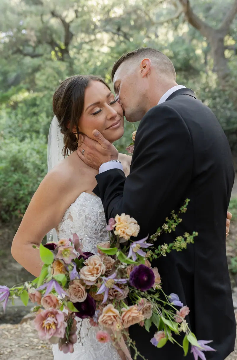 Bride and groom with a bouquet of deep colour